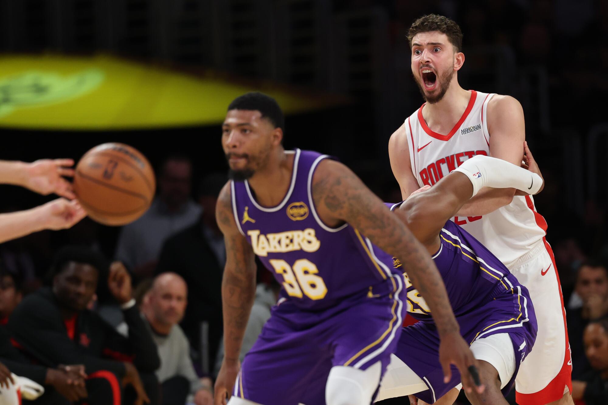 Rockets center Alperen Sengun yells out for the ball while Lakers guard Marcus Smart pressures the Houston ball hander.