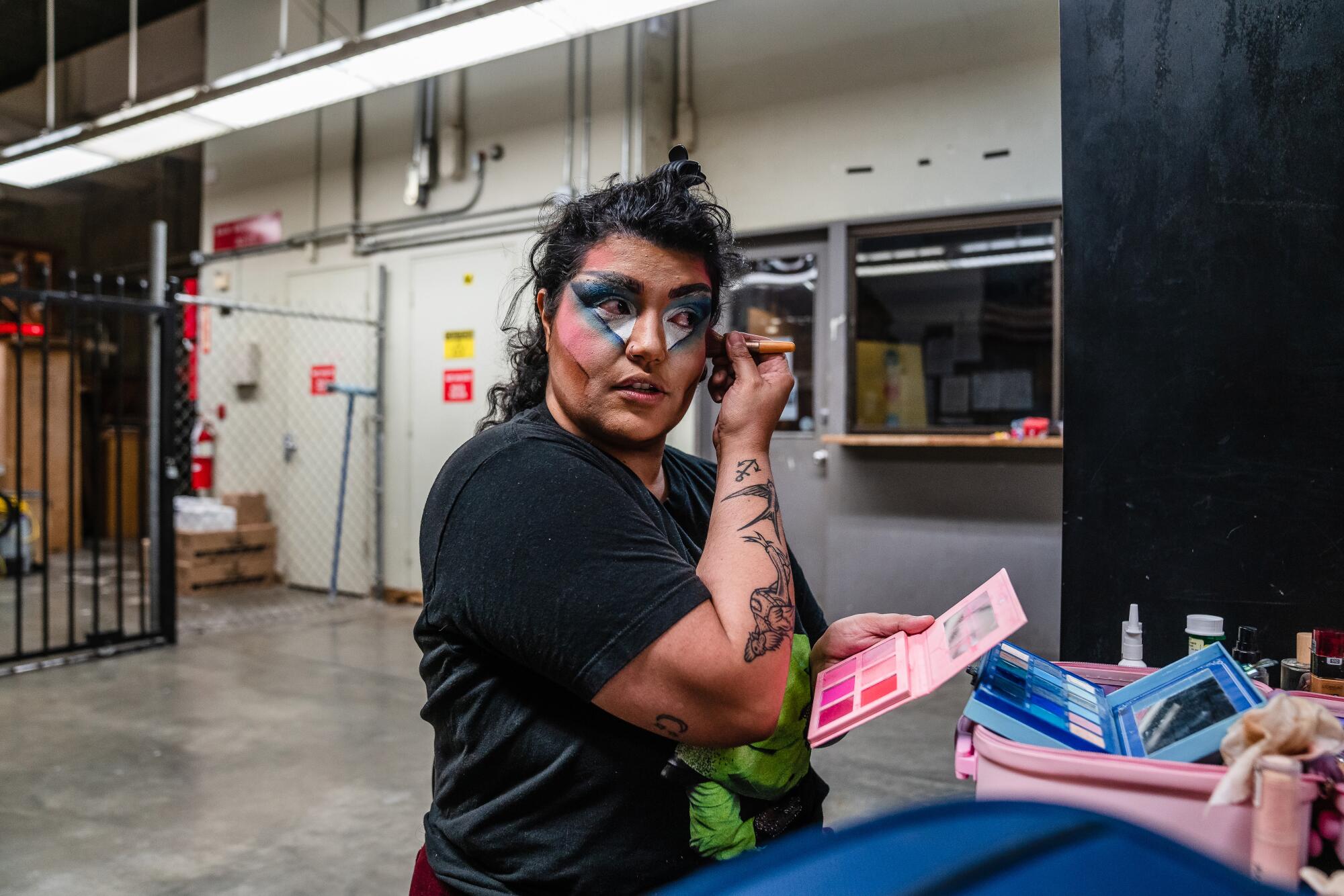 Manny Oakley puts on make-up backstage before performing at the Barnsdall Gallery Theatre