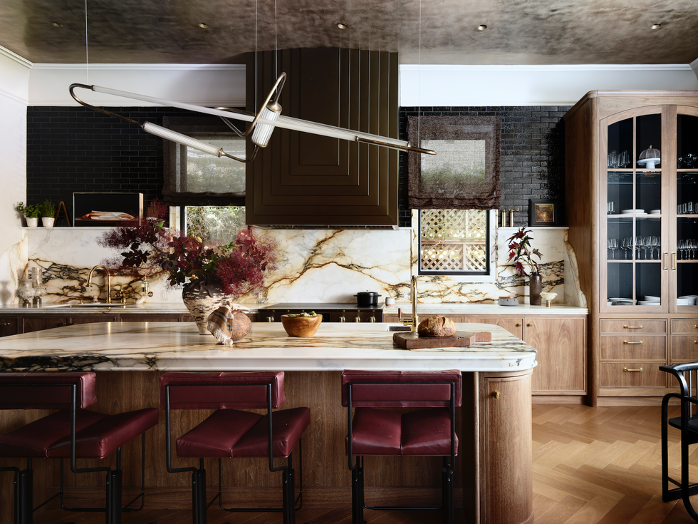 Modern kitchen featuring marble countertops and stylish seating. Modern kitchen featuring marble countertops and stylish seating.