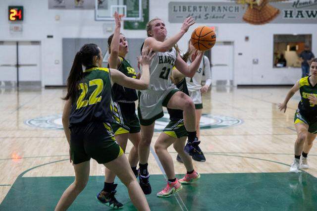 Liberty Ranch’s Haley Smith (21) drives to the basket during a CIF girls basketball playoff game against Sonora at Liberty Ranch High School in Galt on Tuesday, Feb. 13, 2024.