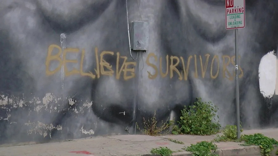 Cesar Chavez mural with words “believe survivors” spray painted on it in downtown Bakersfield. / Photo: KGET