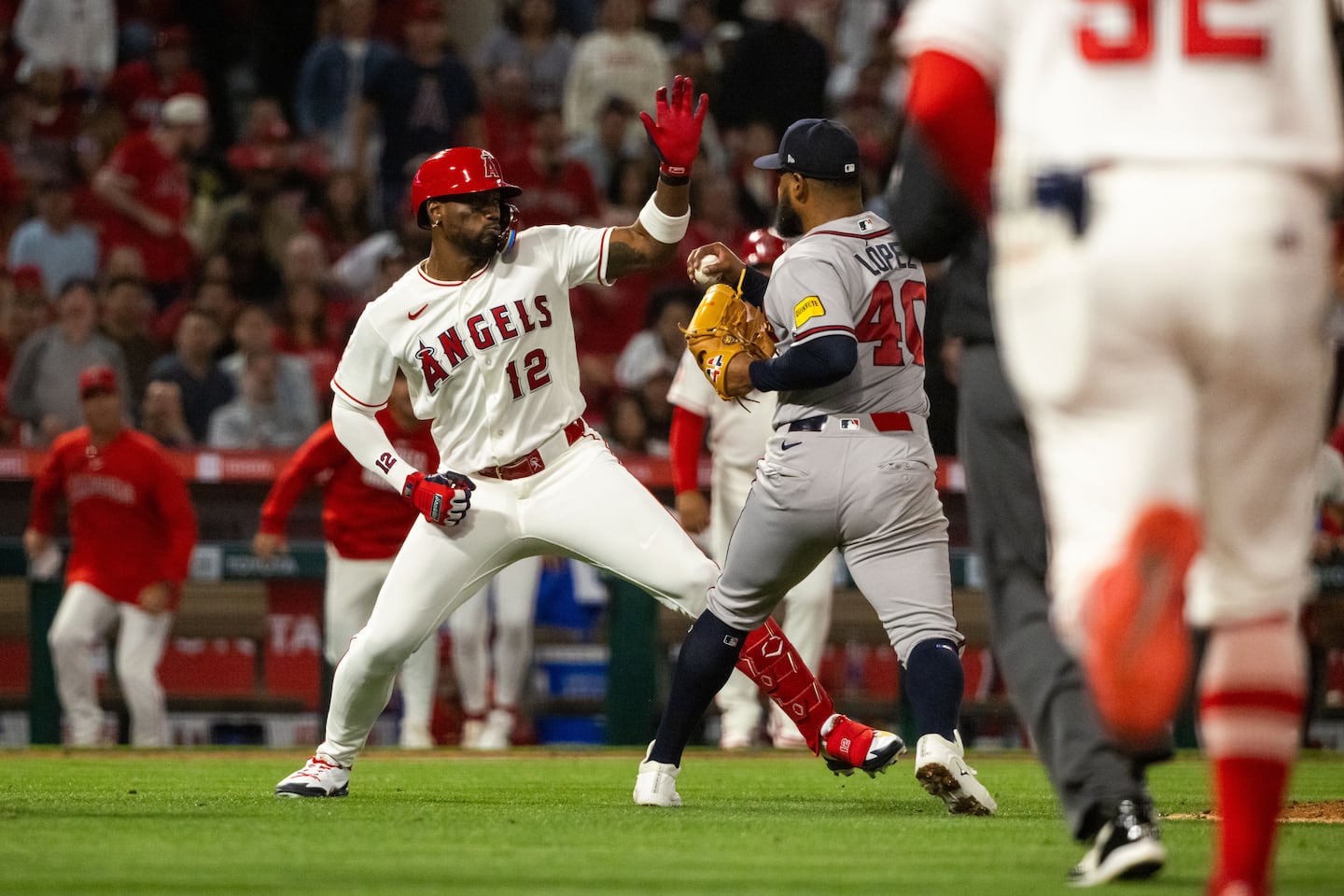 Jorge Soler of the Angels (left) charged Braves pitcher Reynaldo López in the fifth inning on Tuesday night. Both players received seven-game suspensions.