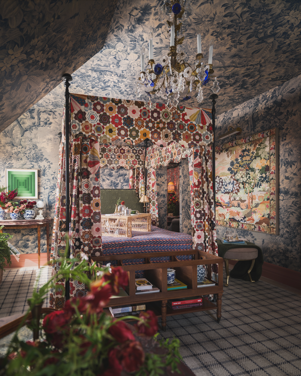 Cozy, ornately decorated bedroom featuring a four-poster bed and intricate wallpaper. Cozy, ornately decorated bedroom featuring a four-poster bed and intricate wallpaper.