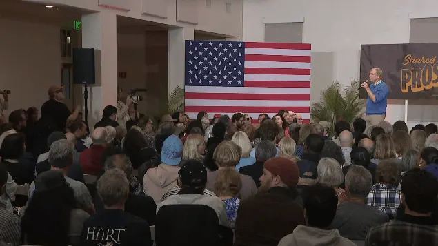 Attendees confront Tom Steyer on his history with previous company ties to a private prison company. (KSWB/KUSI)