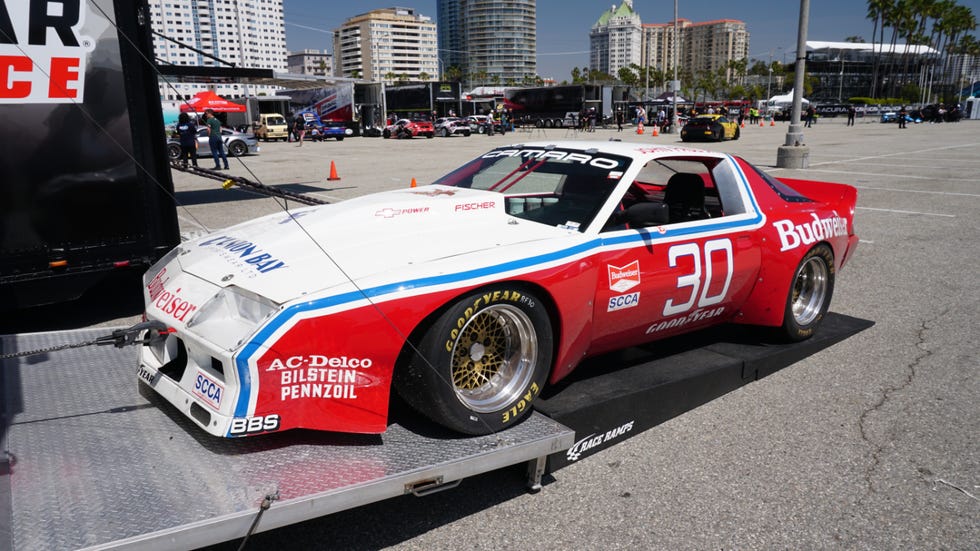 Trans Am Camaro race car displayed on a trailer at a motorsport event