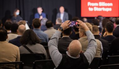 An attendee at a StrictlyVC 2025 event taking a photograph