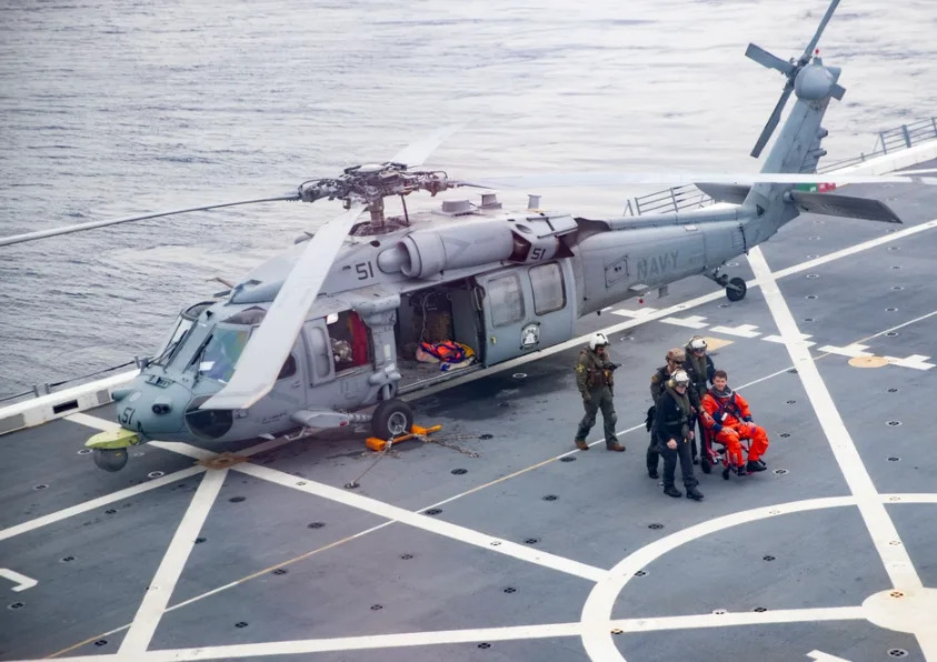 U.S. Navy Sailors assigned to San Antonio class transport dock ship USS San Diego (LPD 22) and Helicopter Sea Combat Squadron 23 “Wildcards” guide U.S. Navy Capt. Reid Wiseman to the ship’s medical facilities from the flight deck during training while underway for NASA’s Underway Recovery Test 11, Feb. 25, 2024. In preparation for NASA’s Artemis II crewed mission, which will send four astronauts in Orion beyond the Moon, NASA and the Department of Defense will conduct a series of tests to demonstrate and evaluate the processes, procedures, and hardware used in recovery operations for crewed lunar missions. The U.S. Navy has many unique capabilities that make it an ideal partner to support NASA, including its amphibious ships with the ability to embark helicopters, launch and recover small boats, three-dimensional air search radar and advanced medical facilities. (U.S. Navy photo by Lt. Caitlyn Strader)