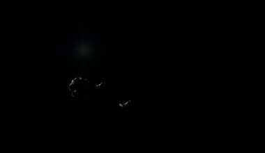 An extreme close-up of a charred, twisted metal object from a crime scene, lit by a harsh, direct camera flash against a pitch-black background, conceptually illustrating the gritty aftermath of a deadly incident.