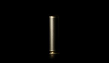 An extreme close-up photograph of a high-powered rifle cartridge casing, the metallic surface reflecting the harsh flash of light against the dark background, conveying the gritty, investigative nature of the incident.