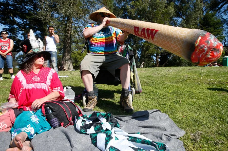 Bear Waite blows up an inflatable joint with his wife Michelle for the annual 4/20 celebration of cannabis on Hippie Hill at Golden Gate Park in San Francisco, Calif. on Friday, April 20, 2018. (Photo By Paul Chinn/The San Francisco Chronicle via Getty Images)