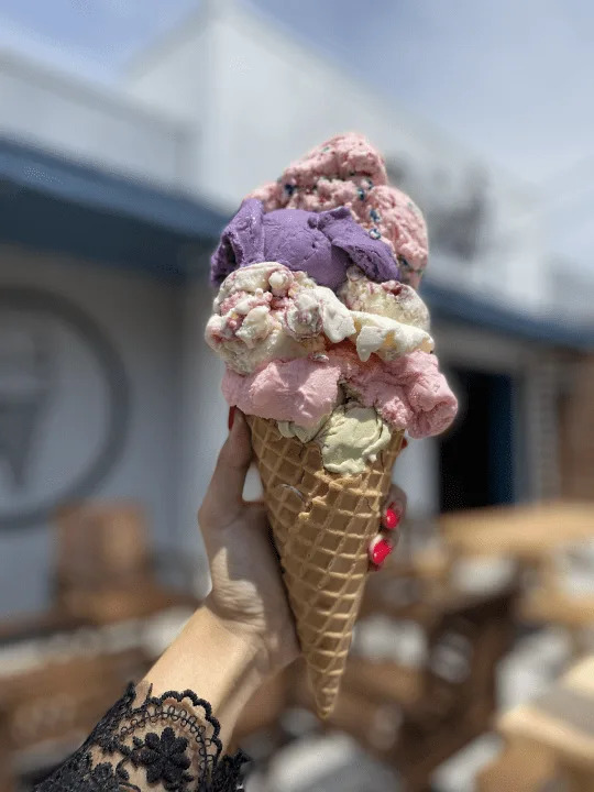 An ice cream cone with multiple scoops of ice cream