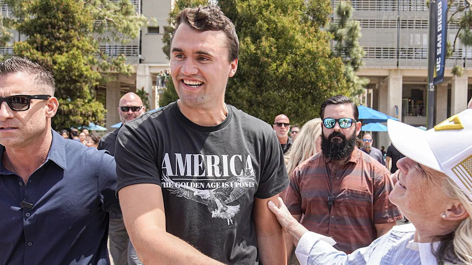 Charlie Kirk talking with supporters in a plaza at UC San Diego