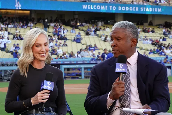 Mar 23, 2025; Los Angeles, California, USA; FanDuel Sports Network reporter Erica Weston (left) and Angels Live analyst Garret Anderson during the game between the Los Angeles Angels and the Los Angeles Dodgers at Dodger Stadium.
