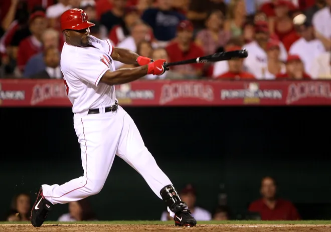 ANAHEIM, CA - OCTOBER 01: Torii Hunter #48 of the Los Angeles Angels of Anaheim hits an RBI single scoring teammate Garret Anderson #16 in the third inning against the Boston Red Sox during game one of the American League Division Series at Angel Stadium on October 1, 2008 in Anaheim, California.
