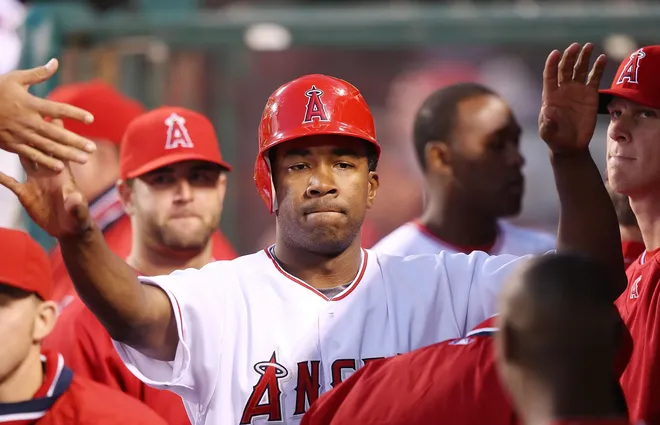 ANAHEIM, CA - APRIL 5: Garret Anderson #16 of the Los Angeles Angels of Anaheim is congratulated by his teammates after scoring in the fourth inning against the Texas Rangers at Angels Stadium April 5, 2008 in Anaheim, California.