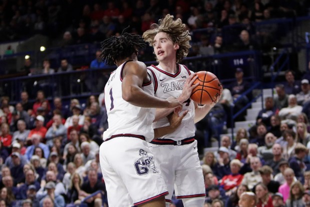 Gonzaga guard Dusty Stromer, right, grabs a rebound next to teammate Michael Ajayi during the second half of their game against Long Beach State on Wednesday night in Spokane, Wash. (AP Photo/Young Kwak)