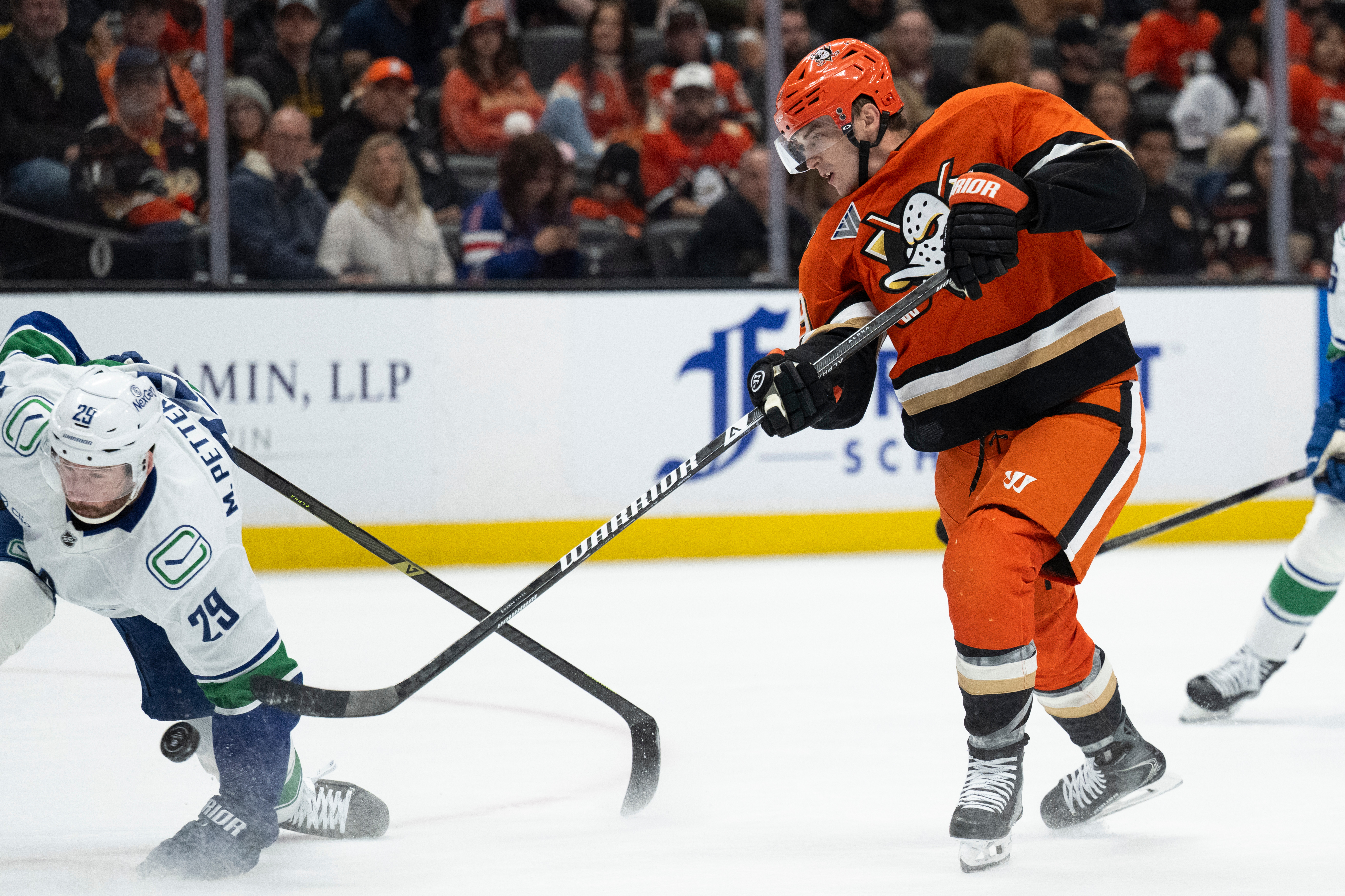 Ducks right wing Troy Terry, right, shoots as Vancouver Canucks...