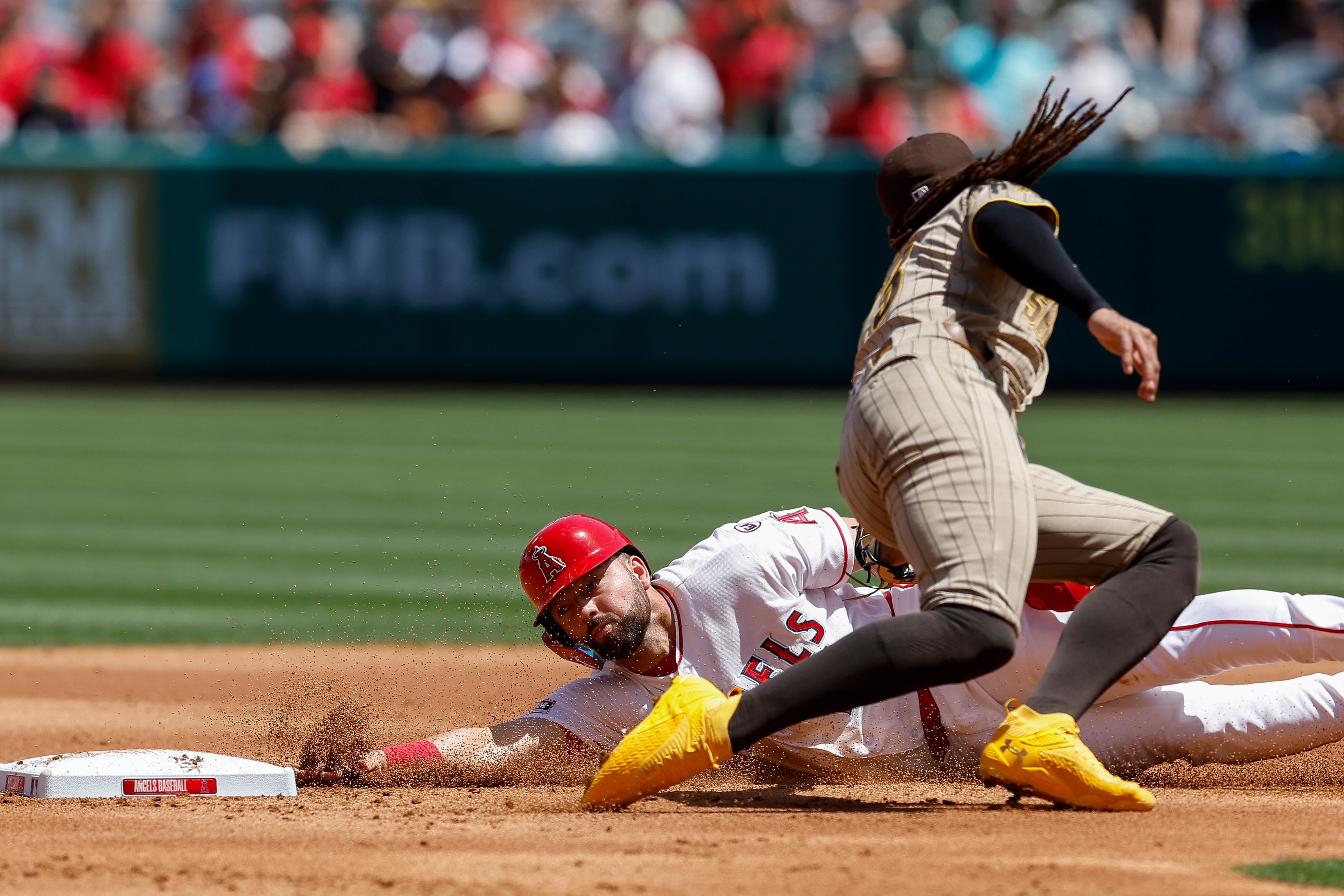 Los Angeles Angels’ Nolan Schanuel, left, slides into second base...
