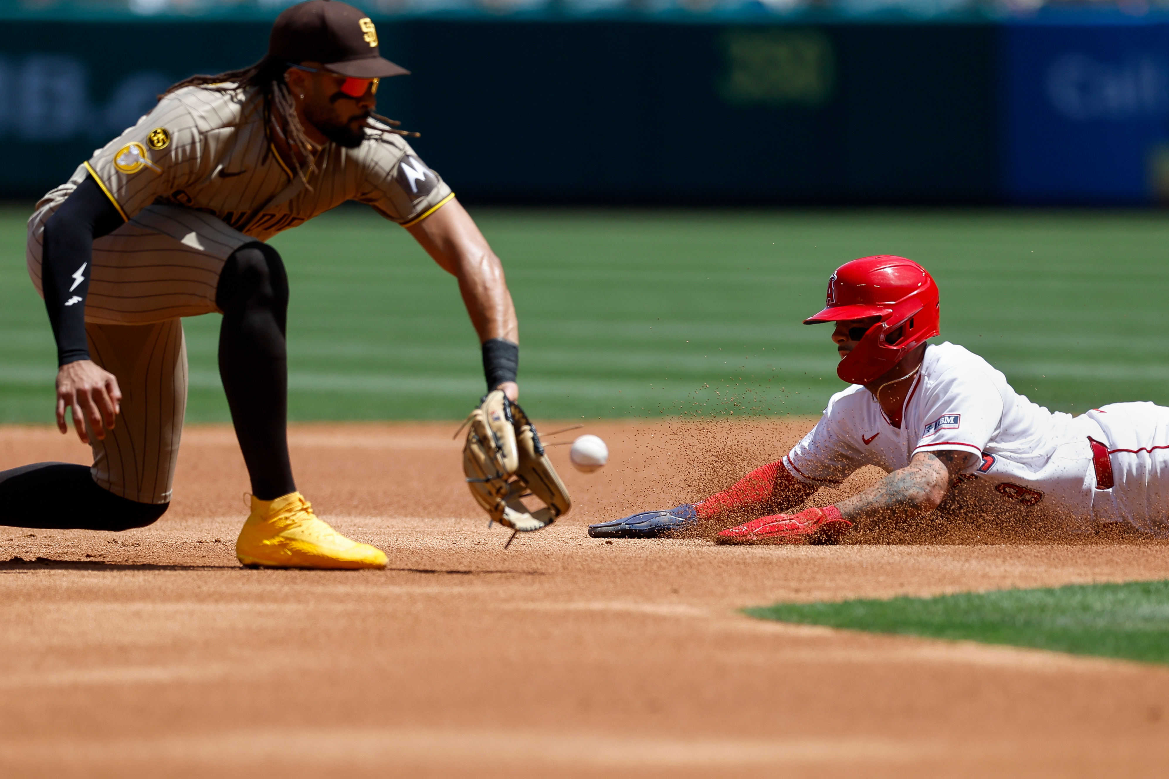 Los Angeles Angels’ Zach Neto, right, slides into second base...