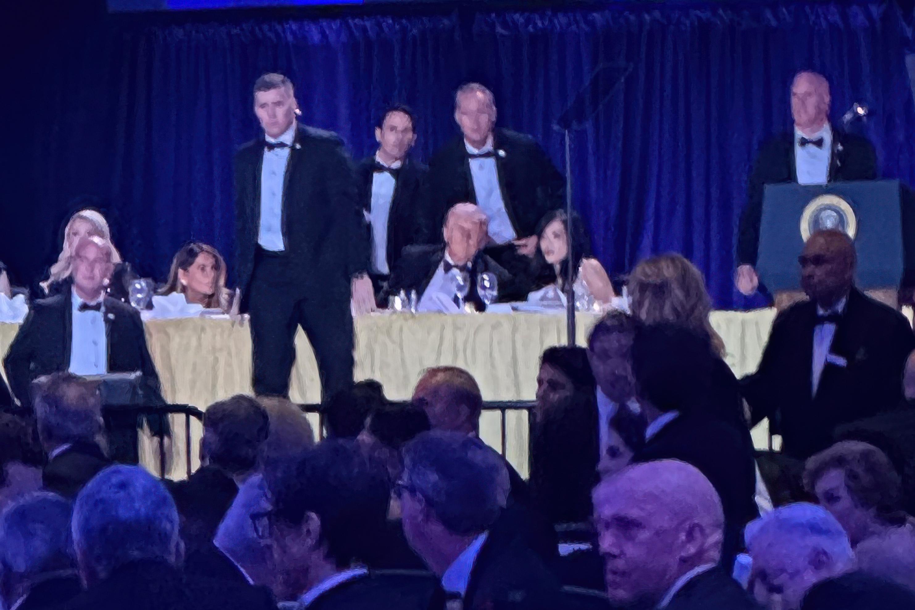 U.S. Secret Service agents surround President Donald Trump during the White House Correspondents' Dinner.