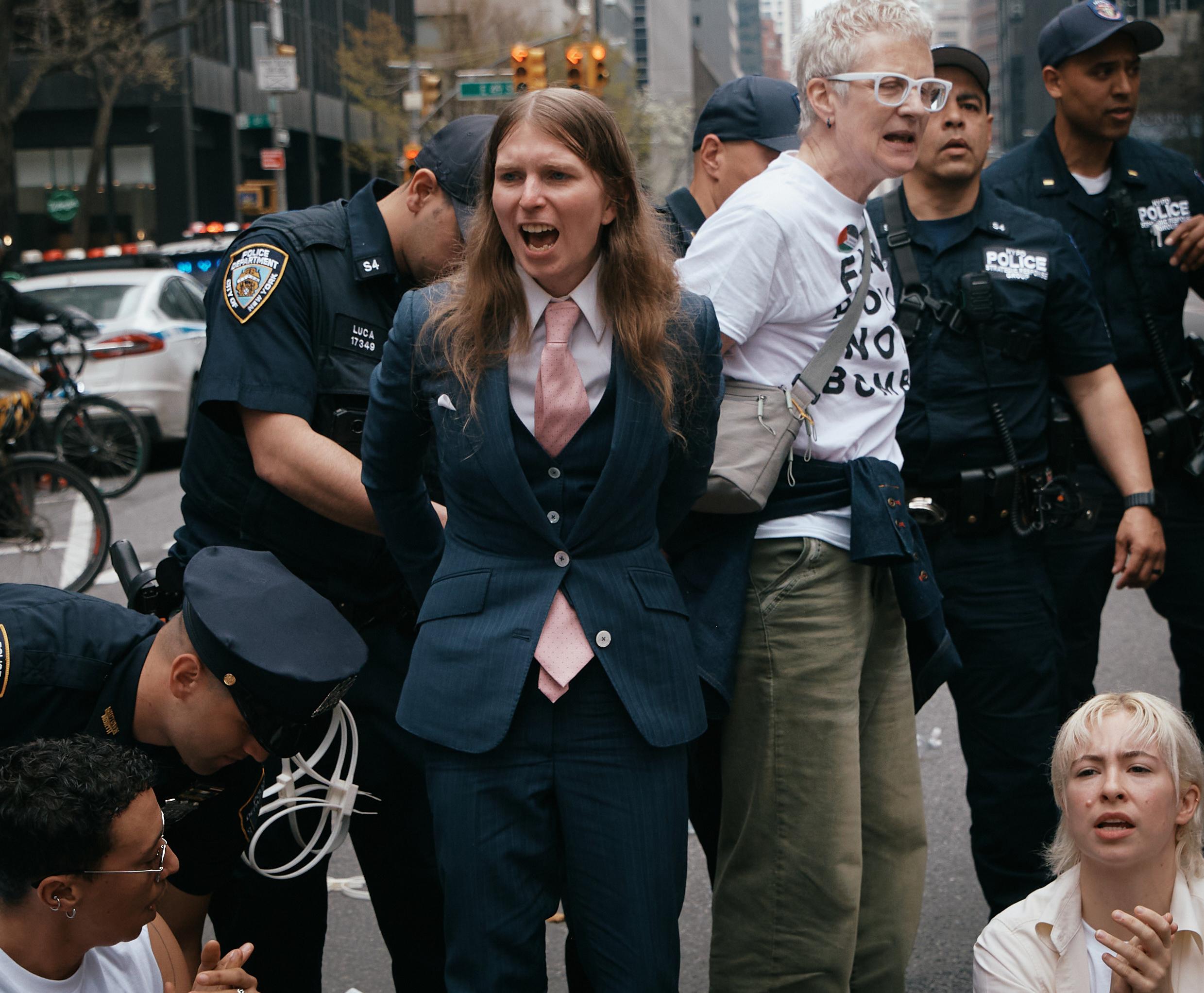 Chelsea Manning, center, is arrested by police as protesters with...