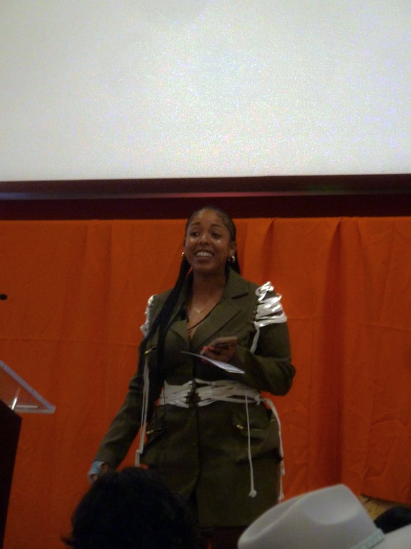 Woman smiling on stage.