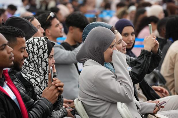 People gather to watch Pope Leo XIV arriving at Maqam Echahid Martyrs' Monument in Algiers.