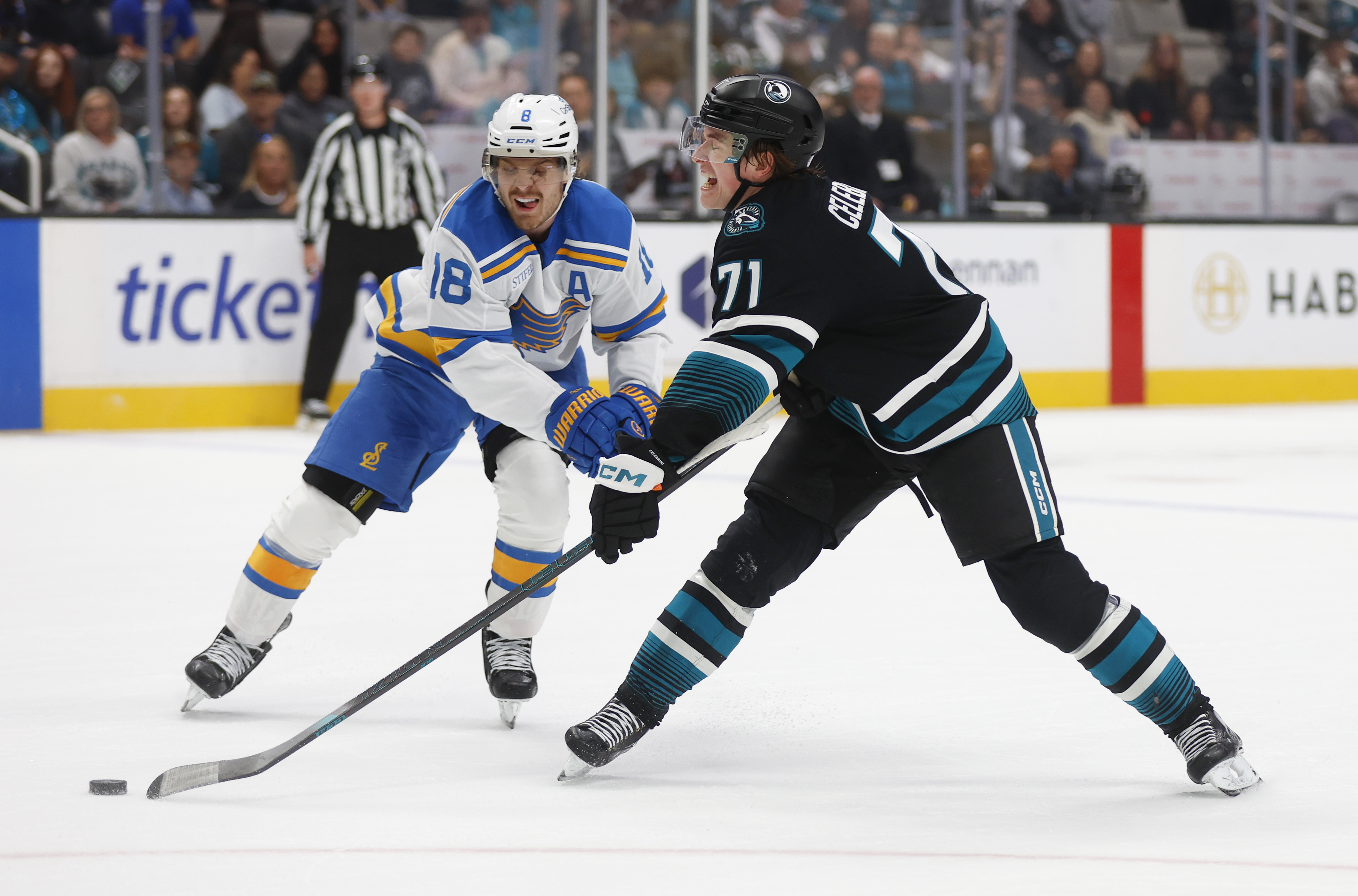 San Jose Sharks' Macklin Celebrini (71) tries to get a...