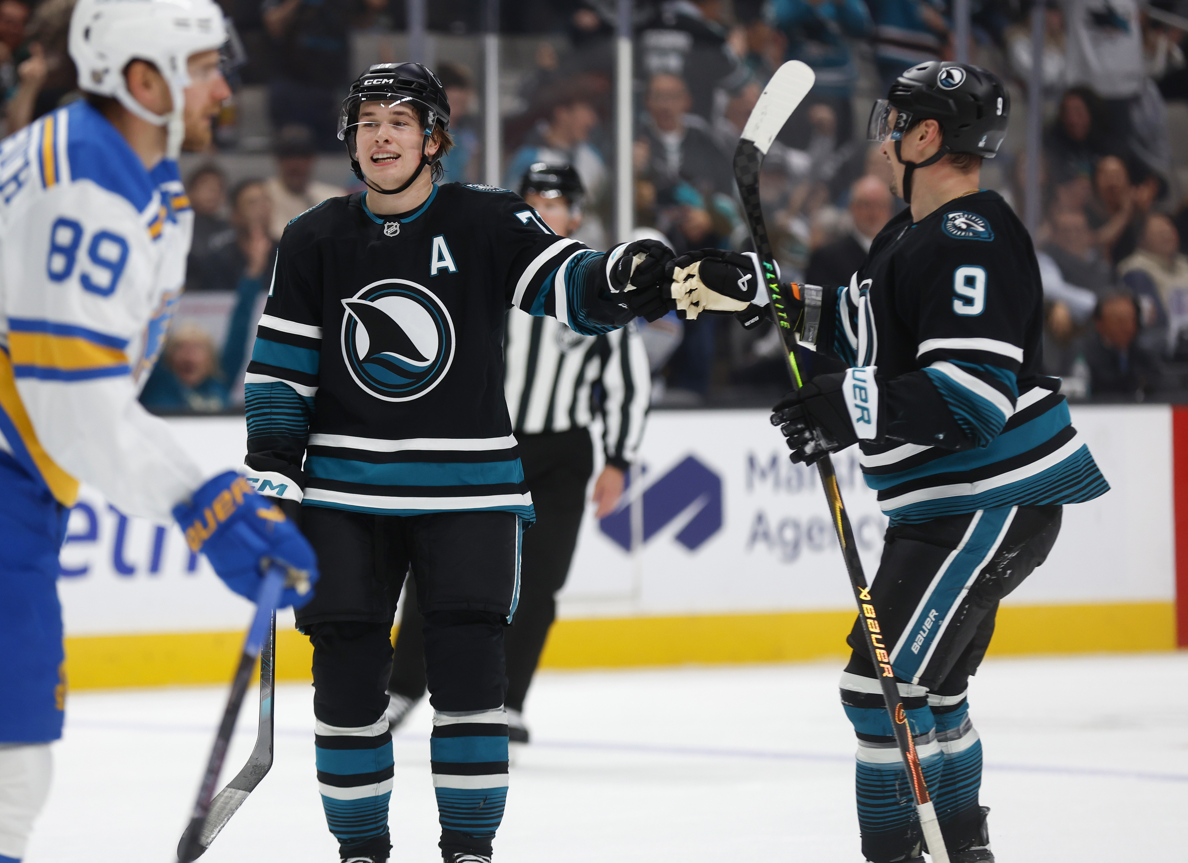 San Jose Sharks' Macklin Celebrini (71) high-fives San Jose Sharks'...