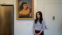 Sophia Bassan stands beside a painting of her grandmother, who died of breast cancer at age 40. With a family history of breast cancer and a genetic test showing she was at risk, Bassan decided to undergo a preventive mastectomy.