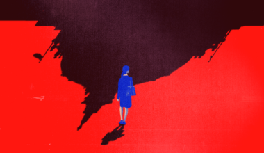 A blue-clad person stands alone at the edge of a large, irregularly shaped black shadow on a vivid red ground.