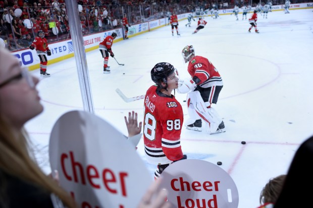 Chicago Blackhawks center Connor Bedard (98) and goaltender Spencer Knight (30) warm up for a game against the San Jose Sharks at the United Center in Chicago on April 15, 2026. (Chris Sweda/Chicago Tribune)