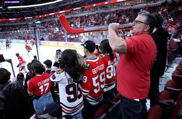 Chicago Blackhawks fan Jon Wiersma (cq) of Lake Zurich takes a drink of beer from his hockey stick vessel as he watches warmups for a game between the Blackhawks and the San Jose Sharks at the United Center in Chicago on April 15, 2026. (Chris Sweda/Chicago Tribune)