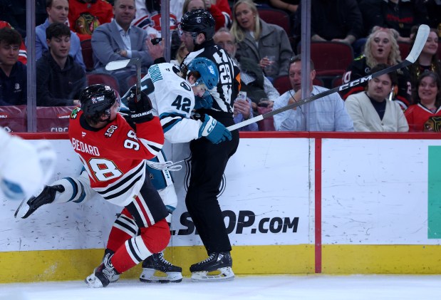 Chicago Blackhawks center Connor Bedard (98) battles San Jose Sharks defenseman Luca Cagnoni (42) along the boards in the first period of a game at the United Center in Chicago on April 15, 2026. (Chris Sweda/Chicago Tribune)