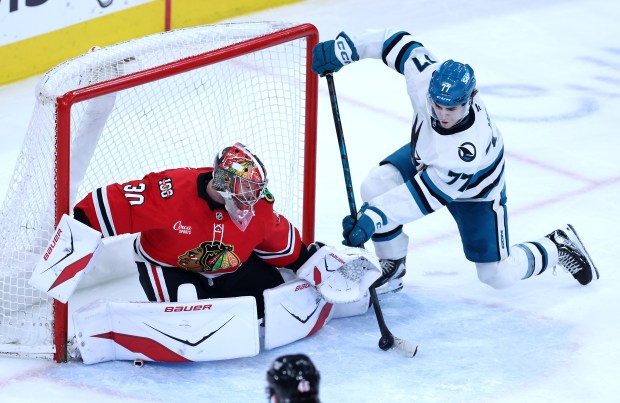 Chicago Blackhawks goaltender Spencer Knight (30) blocks away a shot by San Jose Sharks center Michael Misa (77) in the second period of a game at the United Center in Chicago on April 15, 2026. (Chris Sweda/Chicago Tribune)