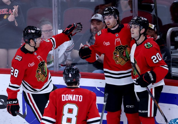 Chicago Blackhawks defenseman Sam Rinzel (center) celebrates with his teammates after scoring a goal in the second period of a game against the San Jose Sharks at the United Center in Chicago on April 15, 2026. (Chris Sweda/Chicago Tribune)