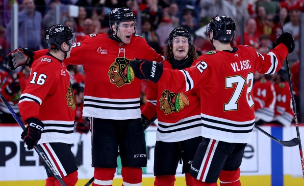 Chicago Blackhawks defenseman Louis Crevier (second from left) celebrates with his teammates after scoring a goal in the third period of a game against the San Jose Sharks at the United Center in Chicago on April 15, 2026. (Chris Sweda/Chicago Tribune)
