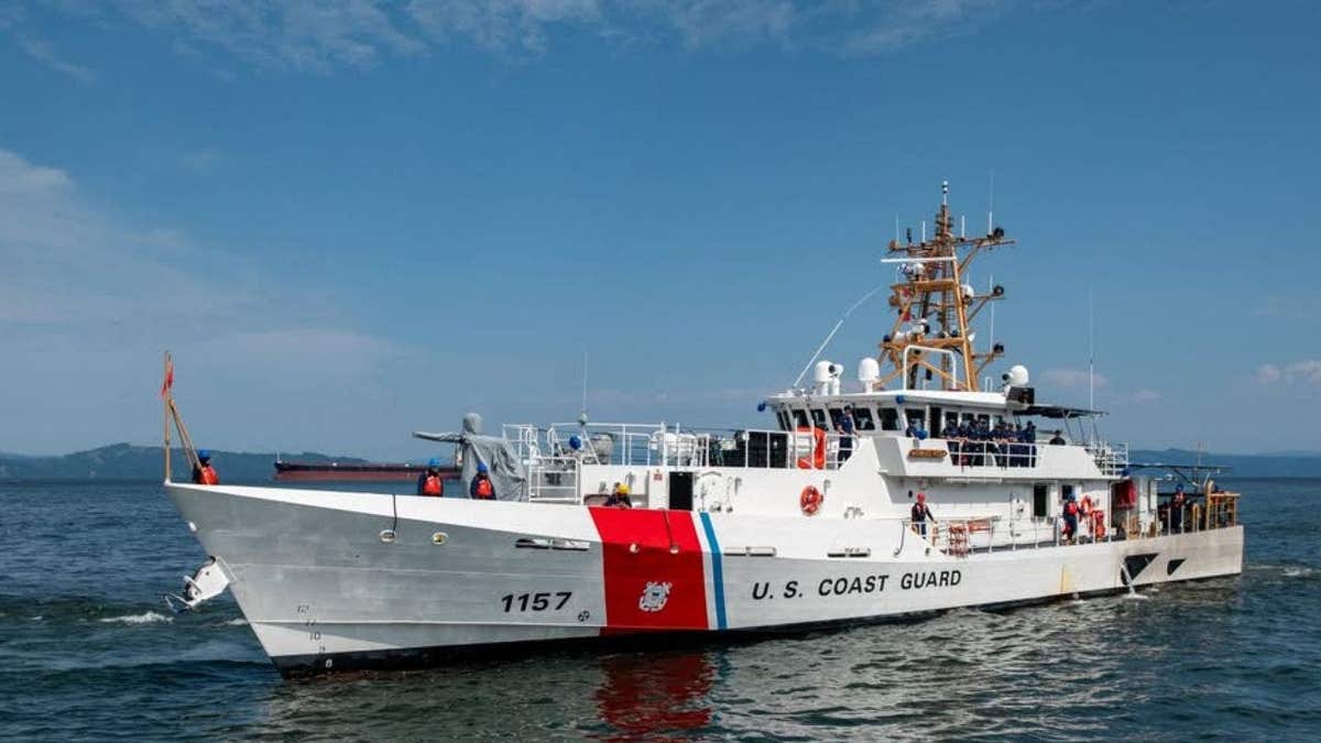 A white and orange Coast Guard patrol boat in the Pacific Ocean