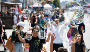 Loads of bubbles and people on the street.
