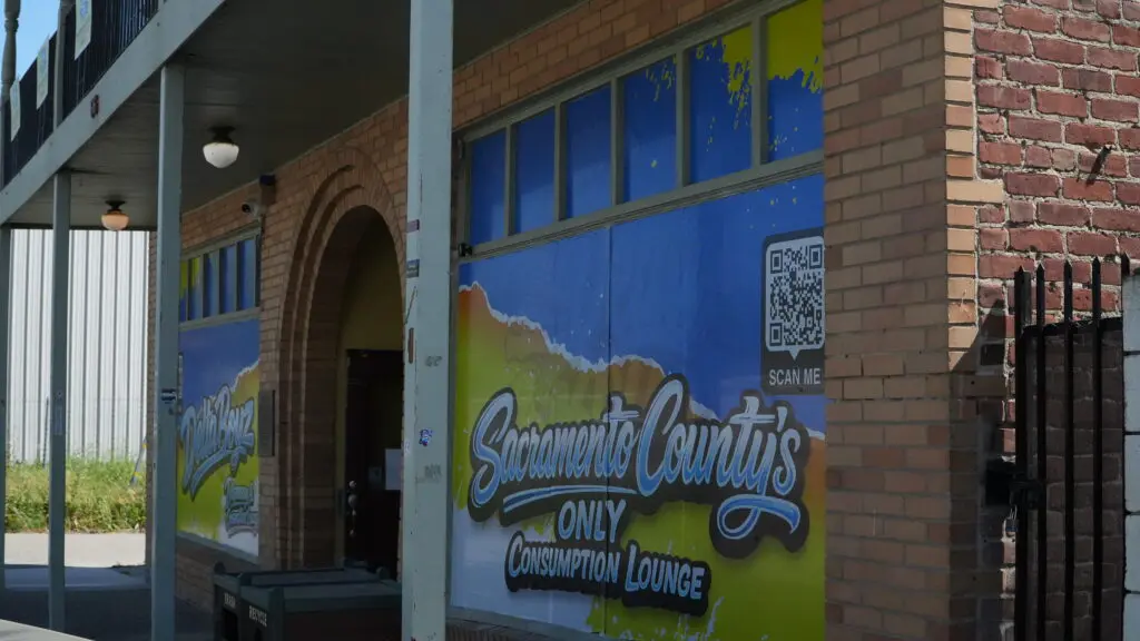 Historic building with the words "consumption lounge" on the windows
