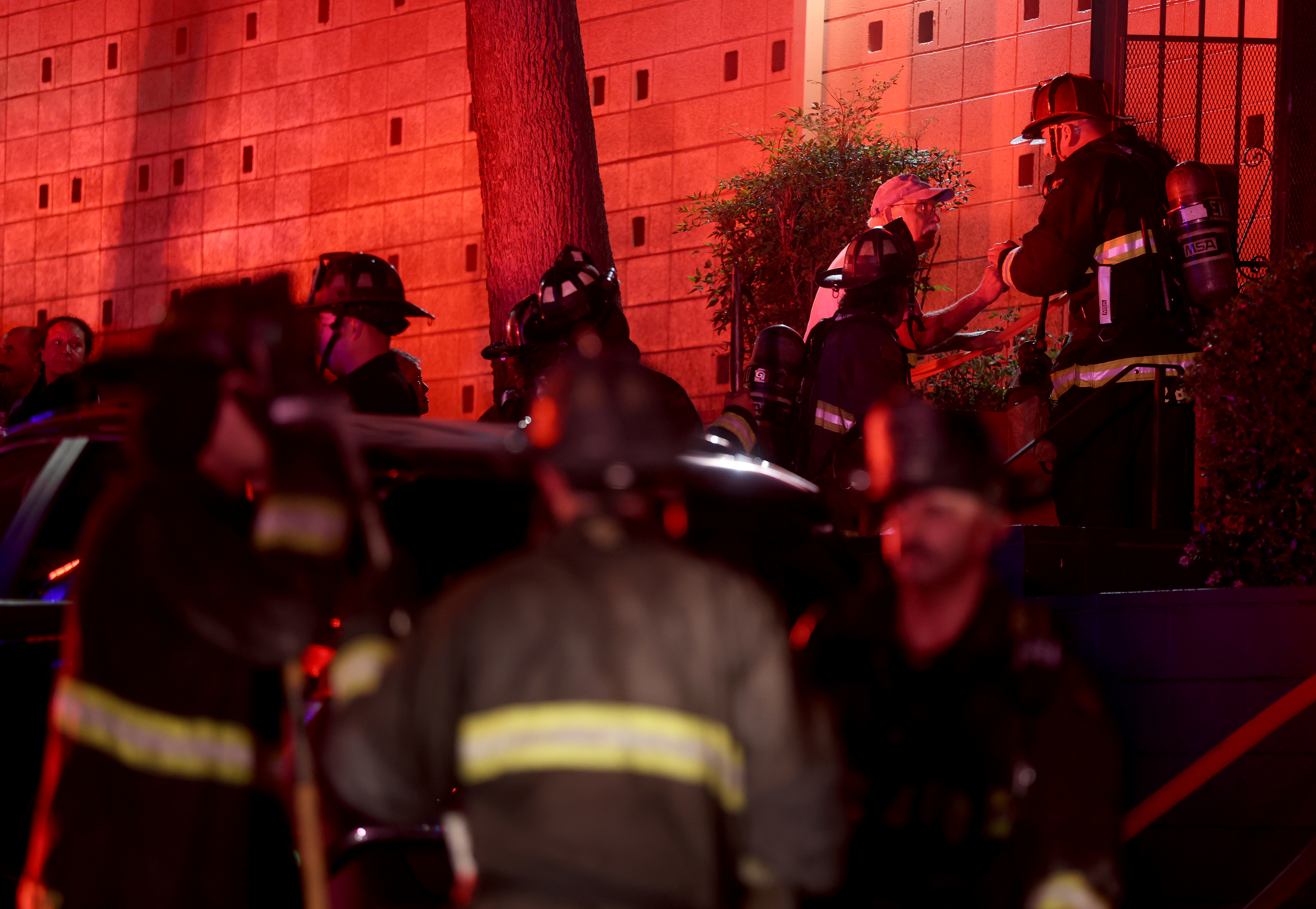 Rory Bannatyne, right, talks with Oakland firefighters to ask them...