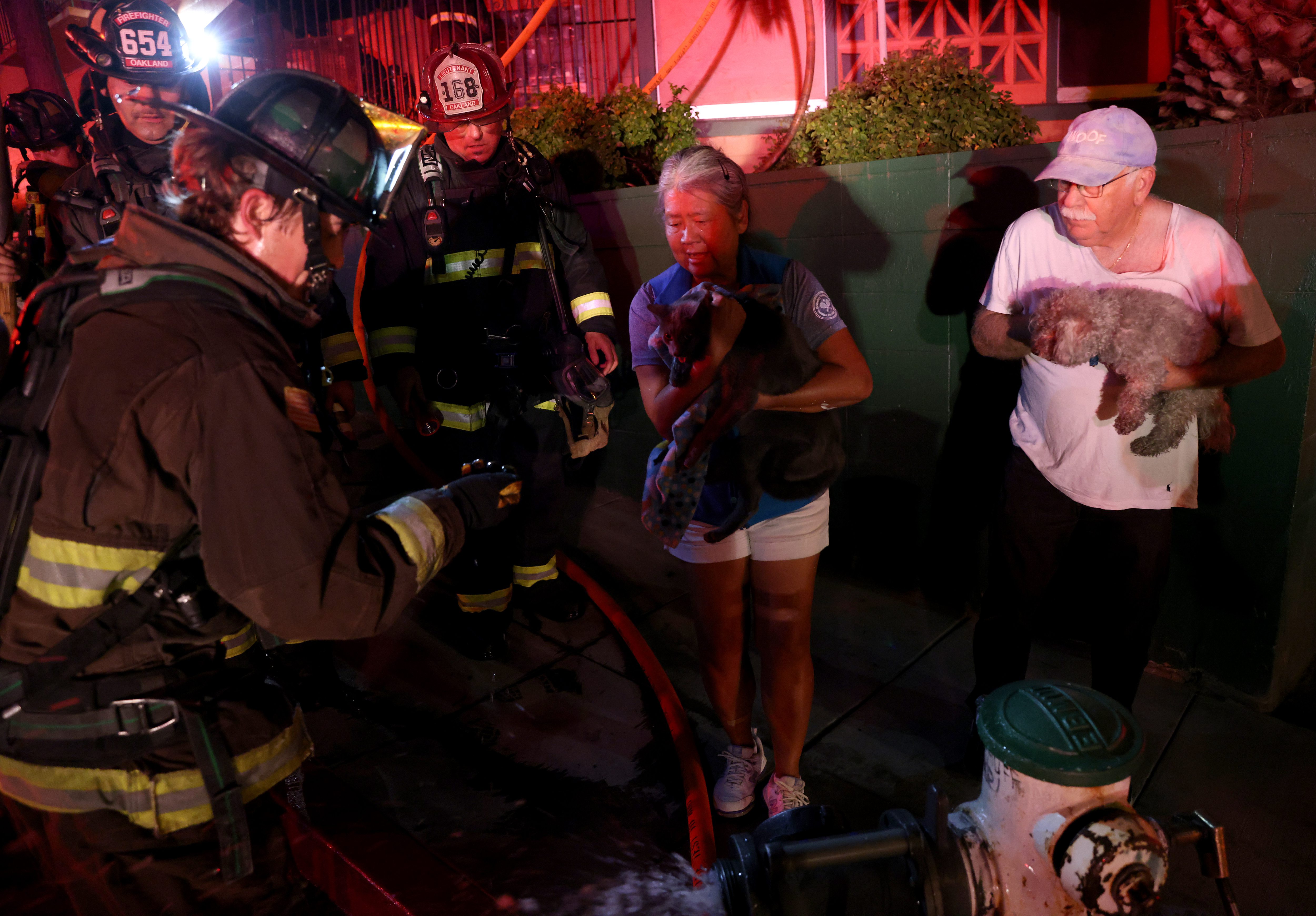Rory Bannatyne and his wife Terri Coleman hold their dog...
