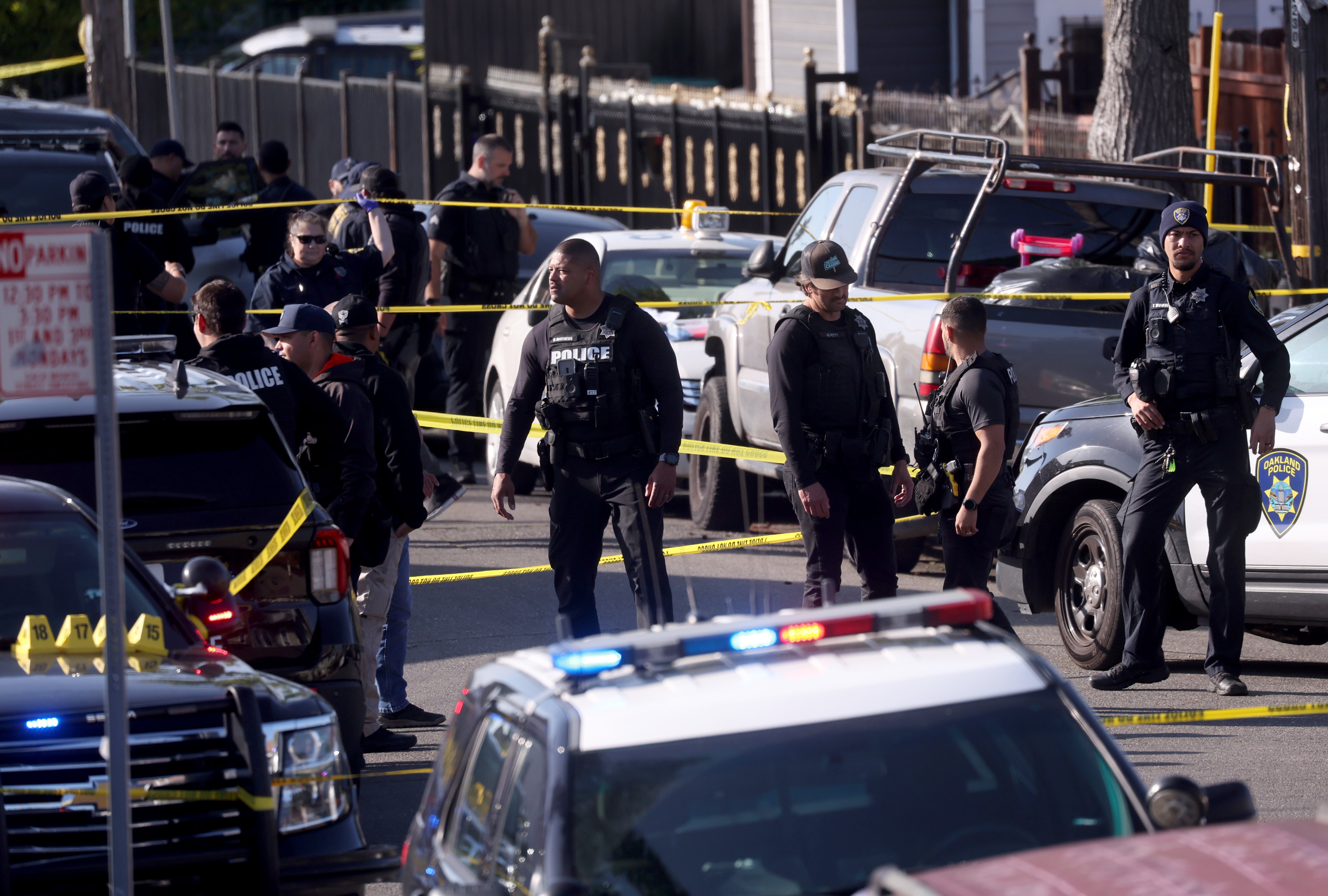 Oakland police officers investigate the scene after shooting a man...