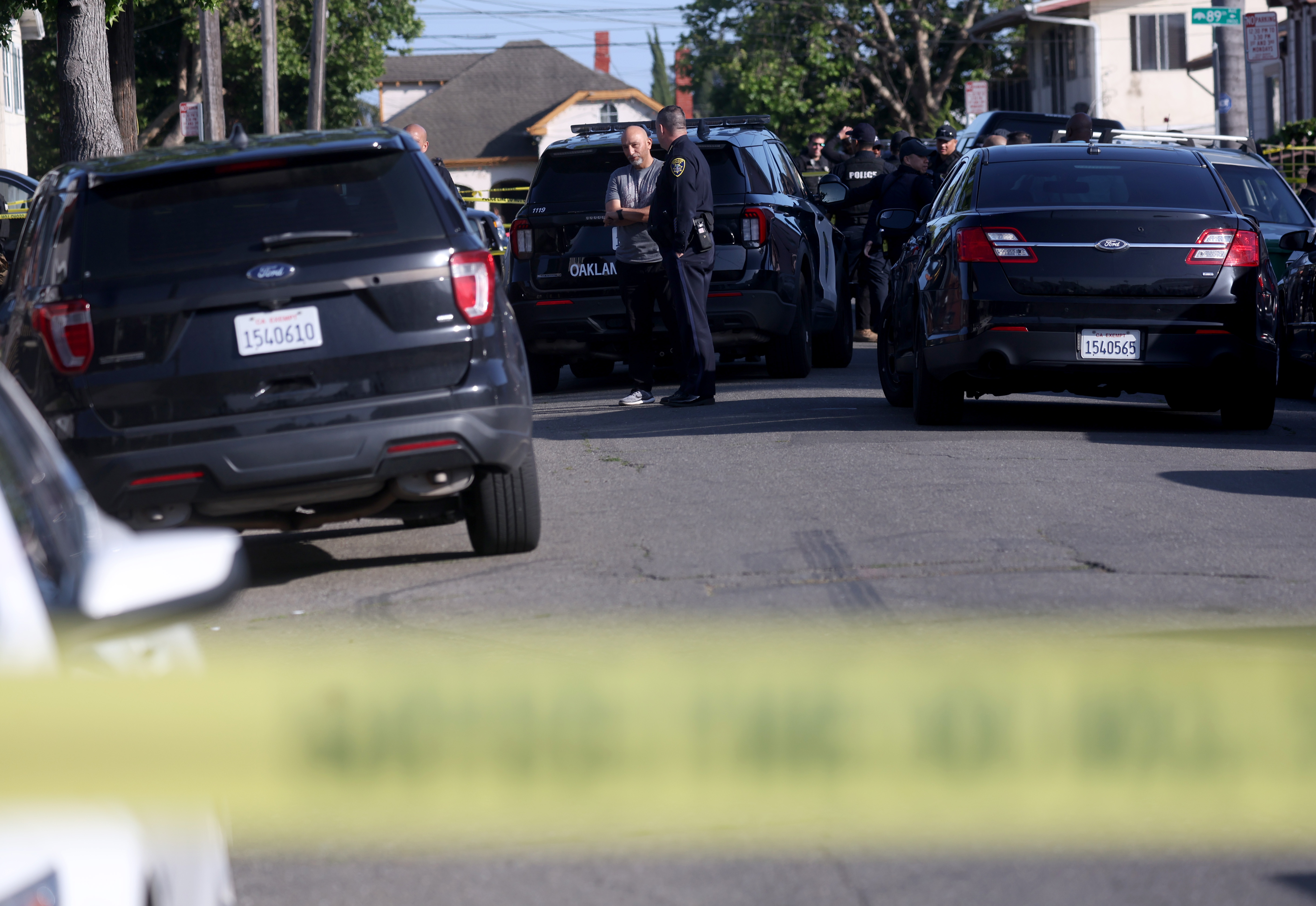 Oakland police officers investigate the scene after shooting a man...