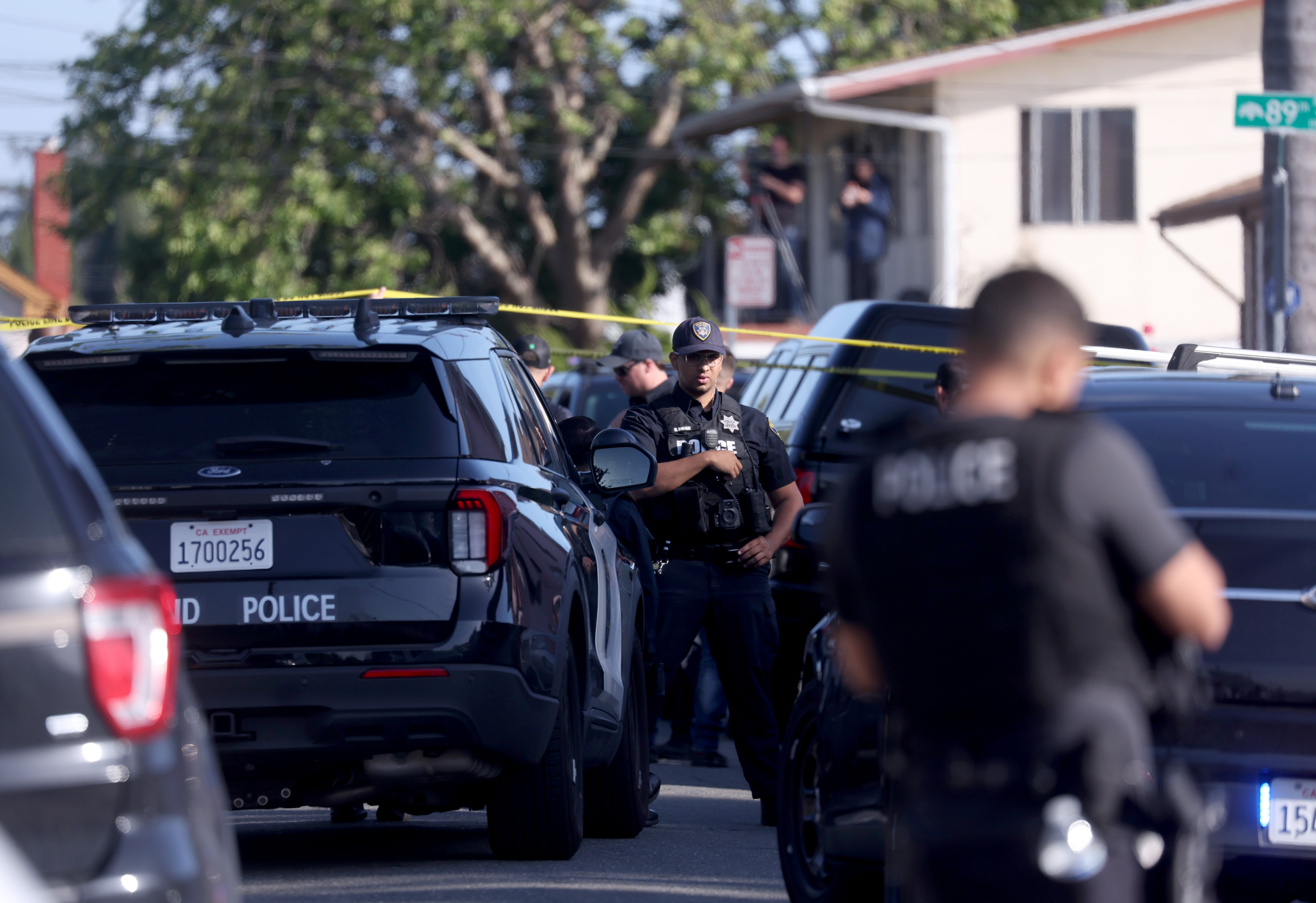 Oakland police officers investigate the scene after shooting a man...