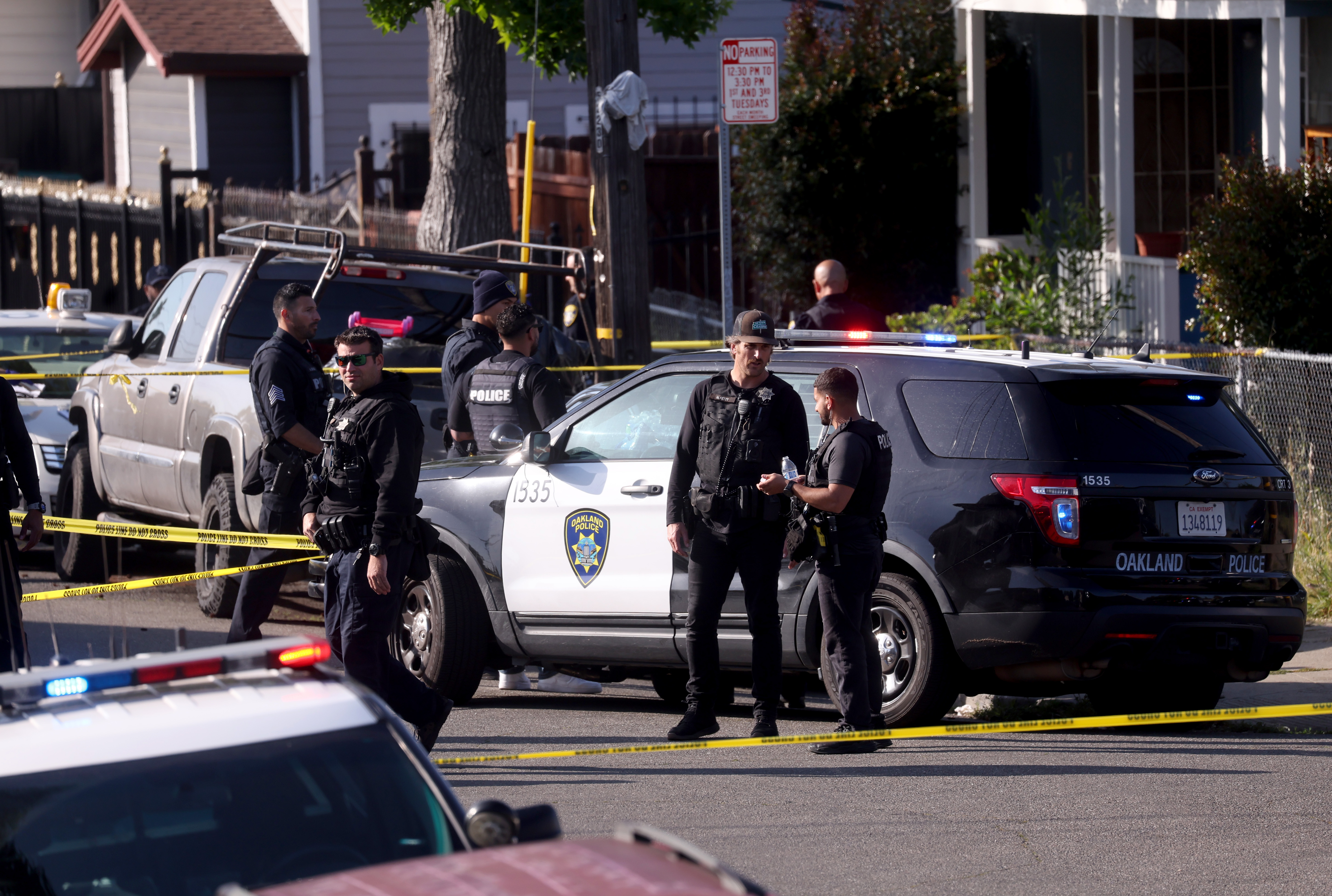 Oakland police officers investigate the scene after shooting a man...