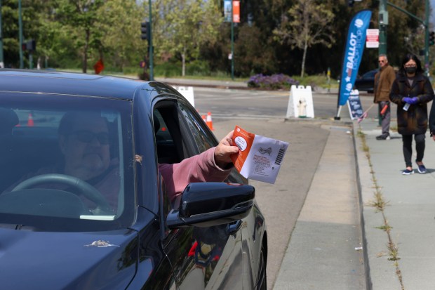 A voter in his vehicle drops off his ballots at the Alameda County Court House during a special Election Day in Oakland, Calif., on Tuesday, April 15, 2025. Oakland voters marked their ballots for the next Oakland Mayor, city council, and sales tax measure races. (Ray Chavez/Bay Area News Group)