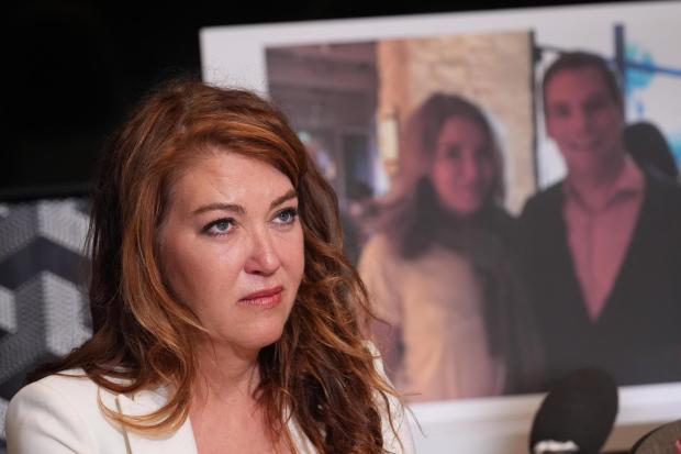 Lonna Drewes reacts during a news conference in Beverly Hills, Calif., Tuesday, April 14, 2026, to detail allegations of sexual misconduct by Rep. Eric Swalwell, after Swalwell exited the California governor's race and said he'll resign his seat in Congress. The AP typically does not identify people who say they are victims of sexual assault unless they identify themselves publicly. (AP Photo/Damian Dovarganes)