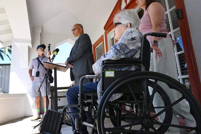 Barbara Mendes, right, listens as attorney Kevin Little, center, addresses the media on behalf of the Fresno Unified Retirees Lifetime Health Benefits Association during a press conference, Friday, April 3, 2026 in Fresno.