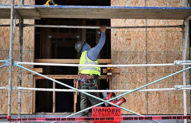A construction worker is seen at The Hubert at Audubon Court, a new luxury apartment complex being built at the northeast corner of Nees Avenue and Audubon Drive. Photographed Wednesday, April 1, 2026 in Fresno.